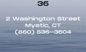 Red 36 at 2 Washington Street in historic downtown Mystic, CT, is a premier waterfront restaurant and bar offering panoramic views of the Mystic River, open-air dining on a spacious deck, and a lively ambiance that draws both locals and visitors.